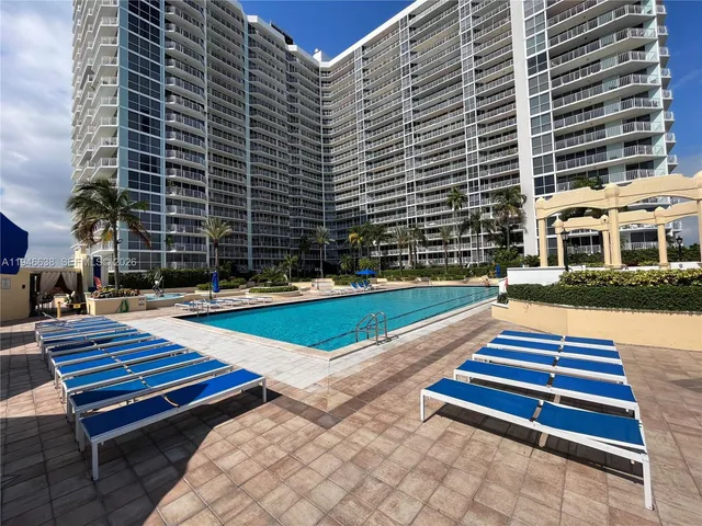 a view of outdoor space with pool and sitting area