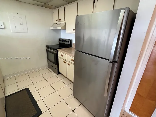 a kitchen with stainless steel appliances a refrigerator and a stove top oven