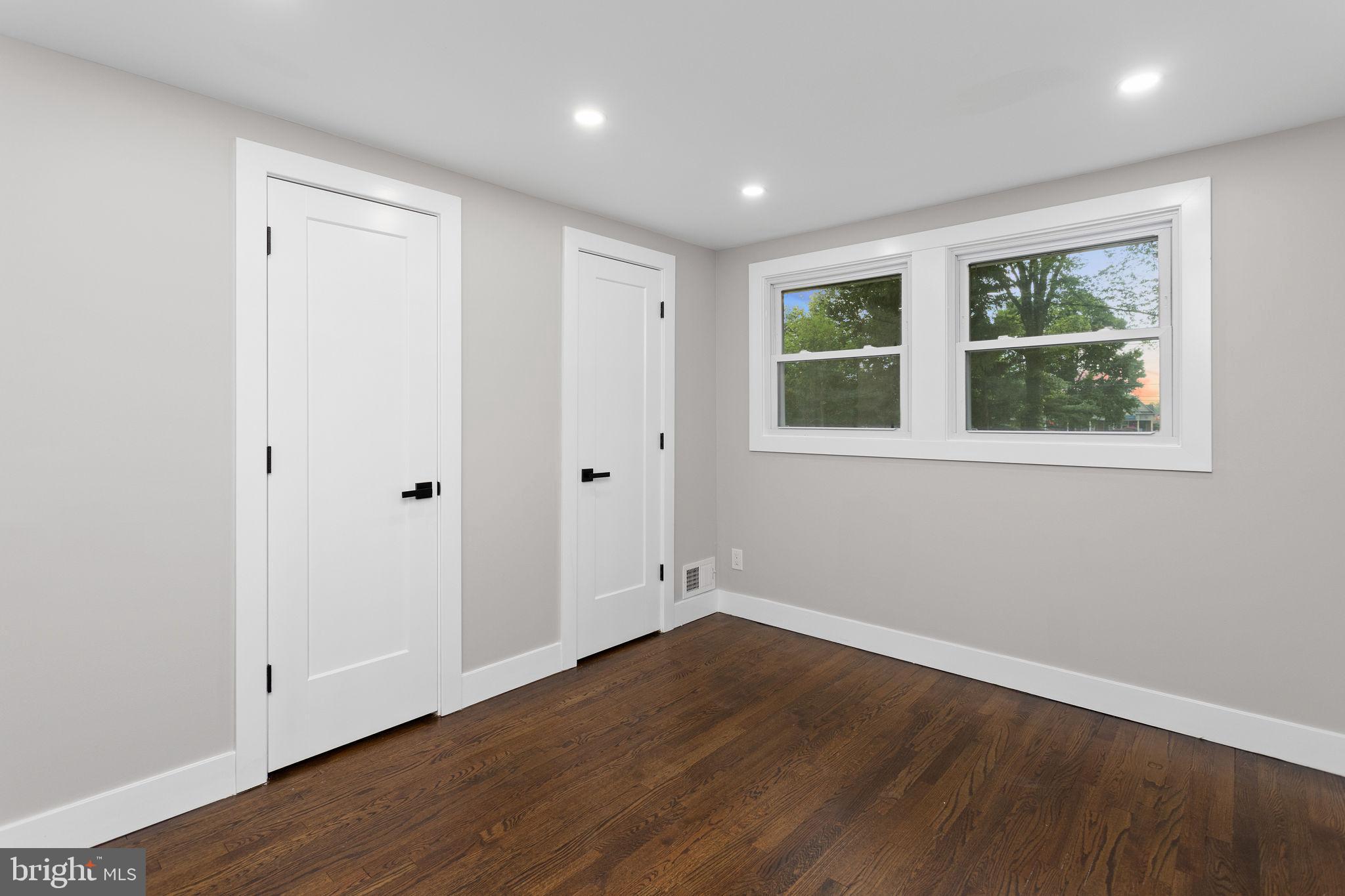 6 Ryan Road Cranbury, NJ 08512 - Photo 17 of 44 an empty room with wooden floor and windows