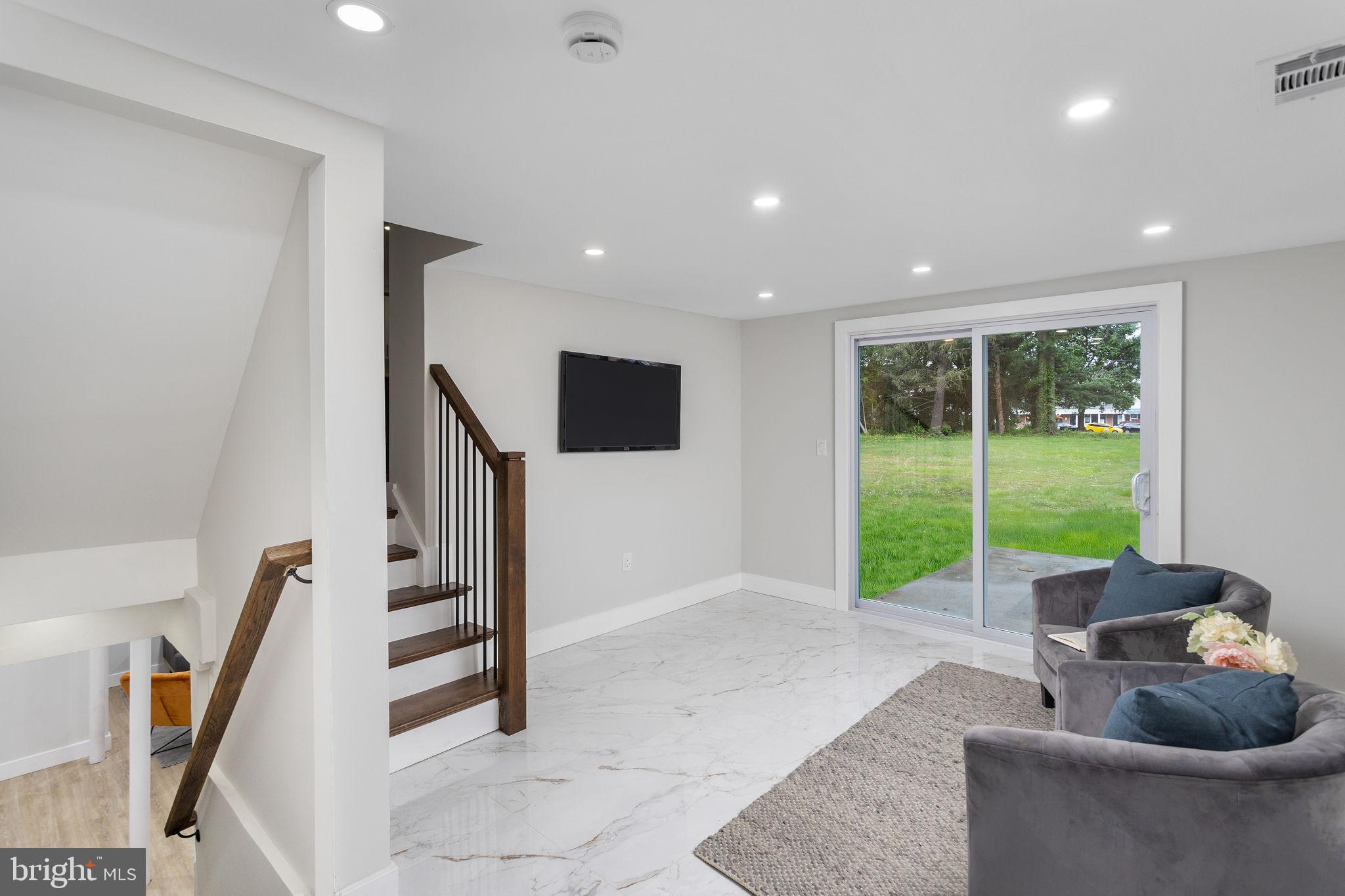 6 Ryan Road Cranbury, NJ 08512 - Photo 22 of 44 a living room with furniture and a floor to ceiling window