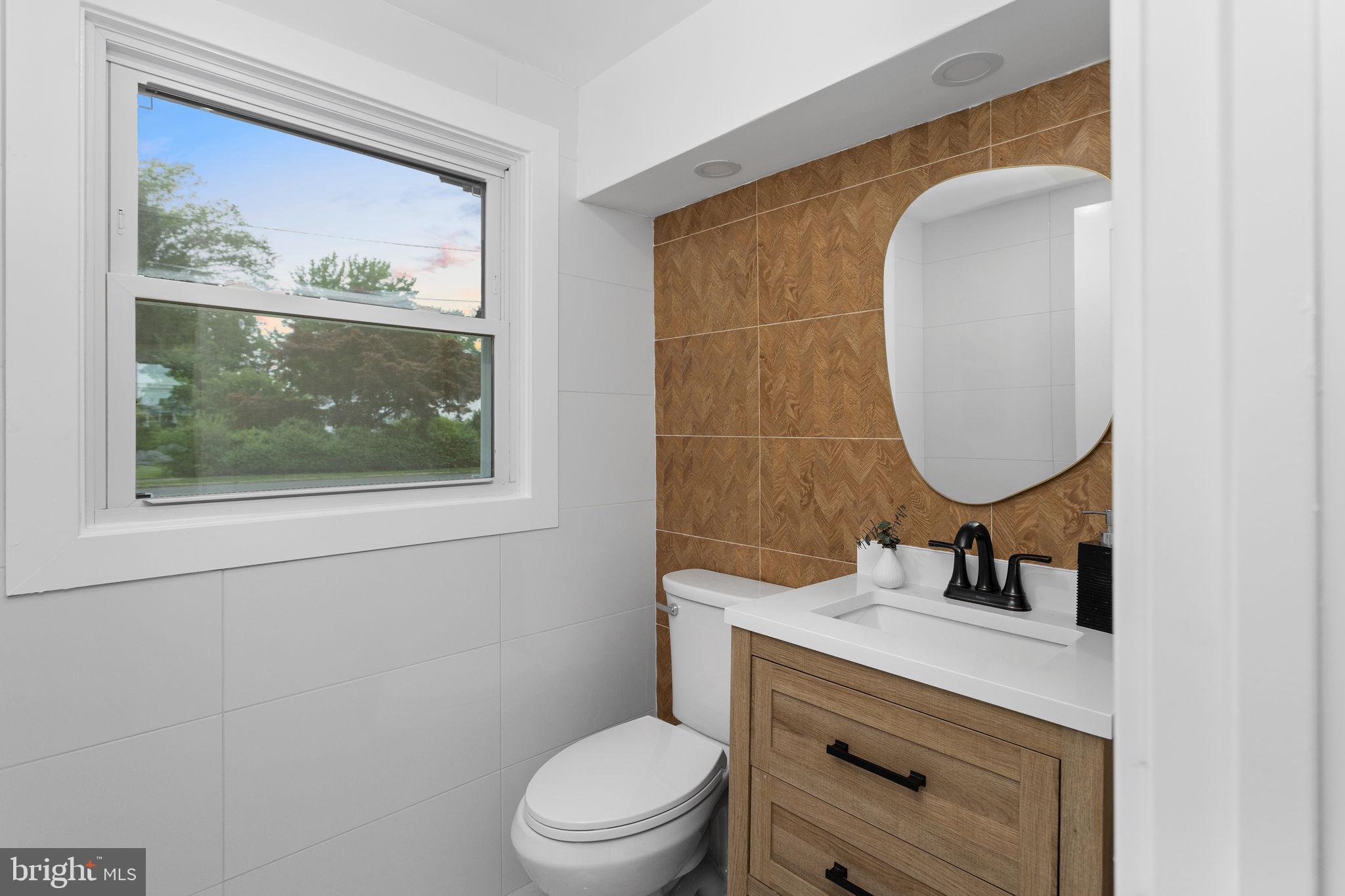 6 Ryan Road Cranbury, NJ 08512 - Photo 24 of 44 a bathroom with a toilet a sink and mirror