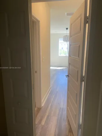 a view of hallway with wooden floor