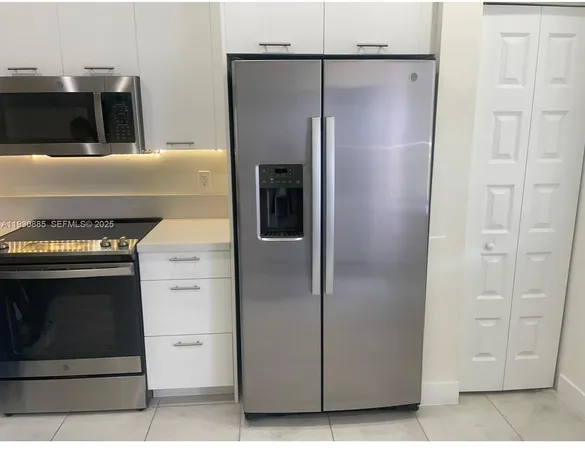 a kitchen with a refrigerator and a stove