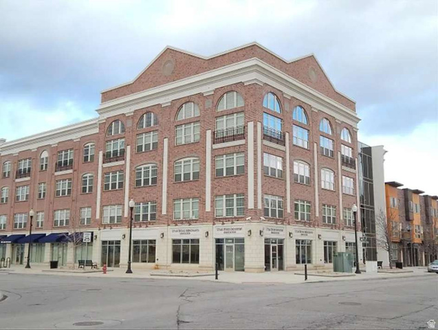 4276 South Main Street, Unit 303 Murray, UT 84107 - Photo 1 of 20 Brick facade building featuring arched windows, stone-clad ground level, and multiple retail storefronts