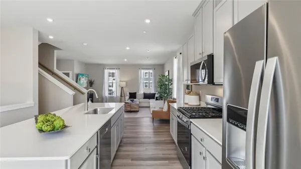 a kitchen with stainless steel appliances a white stove top oven and sink