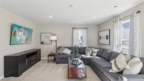 a living room with furniture and a night stand