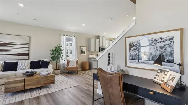 a living room with furniture fireplace and a table