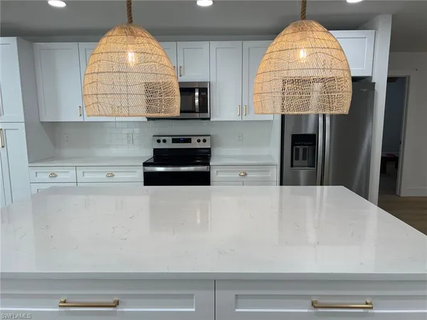 a kitchen with a sink a window and a counter top space