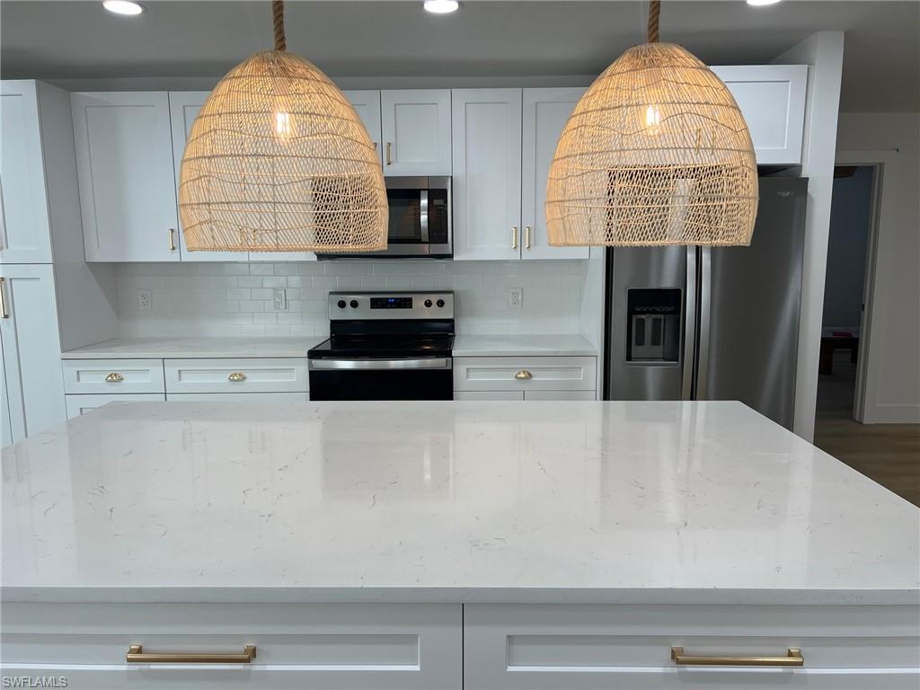 673 107th Avenue North Naples, FL 34108 - Photo 13 of 15 a kitchen with a sink a window and a counter top space