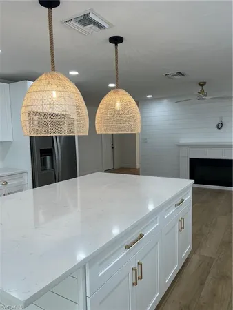 a kitchen with a chandelier and fireplace