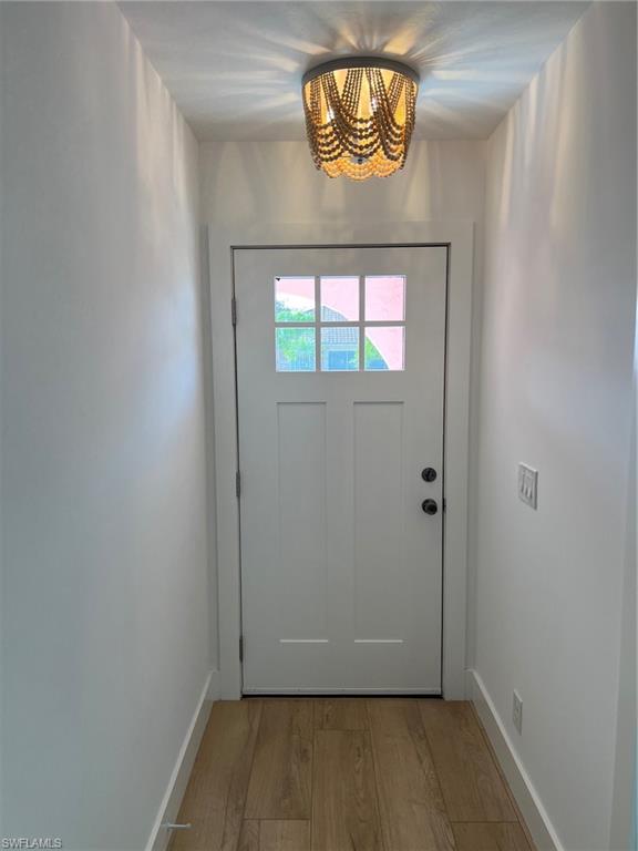 673 107th Avenue North Naples, FL 34108 - Photo 3 of 15 an empty room with wooden floor