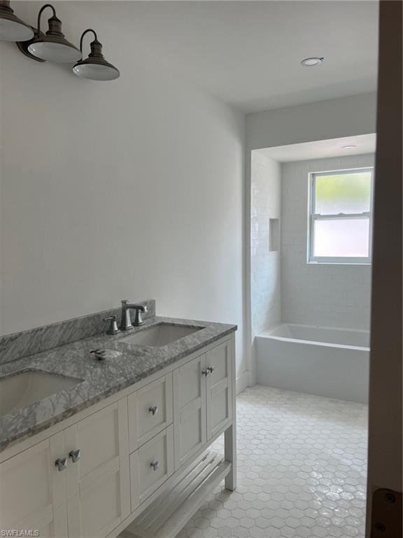 673 107th Avenue North Naples, FL 34108 - Photo 6 of 15 a bathroom with a granite countertop sink and a mirror
