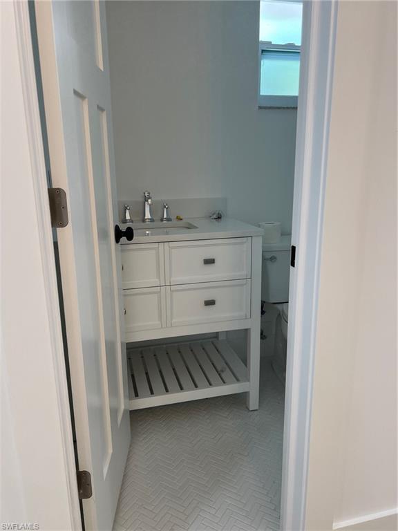 673 107th Avenue North Naples, FL 34108 - Photo 7 of 15 a bathroom with a sink and mirror