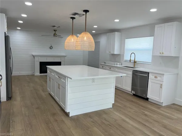 a kitchen with a sink and a stove top oven