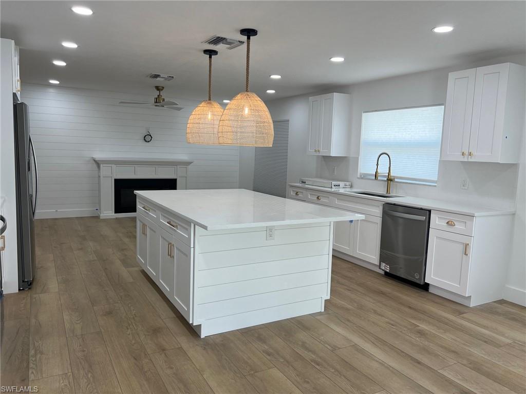 673 107th Avenue North Naples, FL 34108 - Photo 9 of 15 a kitchen with a sink and a stove top oven