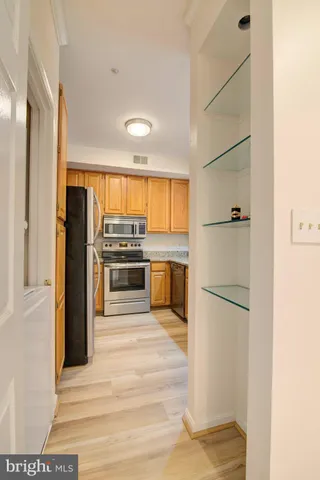 a kitchen with stainless steel appliances a refrigerator and a stove top oven