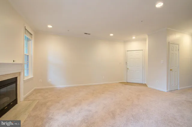 a view of an empty room with a fireplace