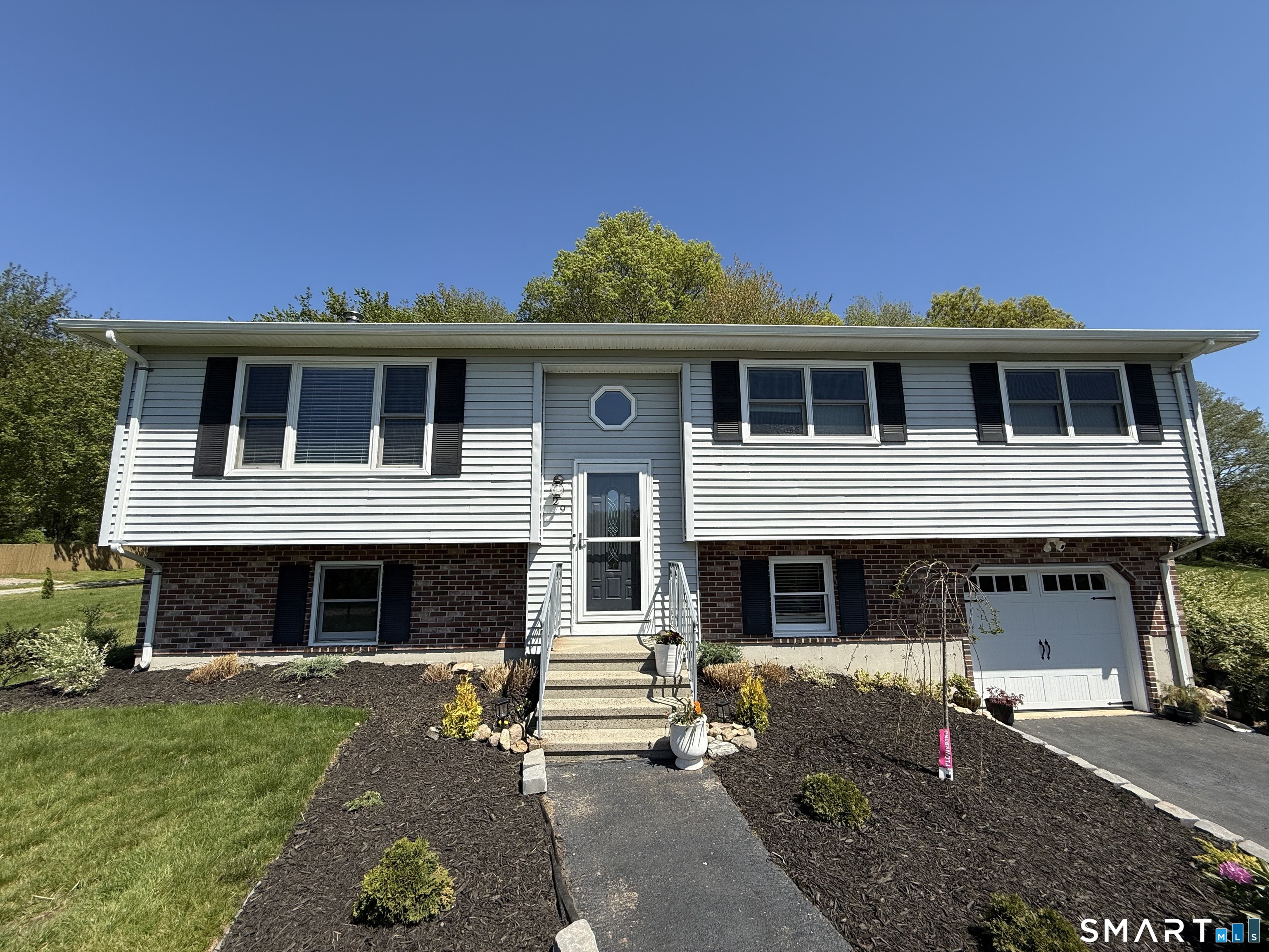 29 Deer Ridge Road Stonington, CT 06378 - Photo 2 of 35 a front view of a house with a yard
