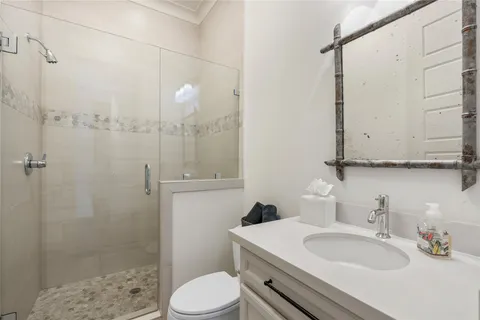 a bathroom with a sink toilet and shower