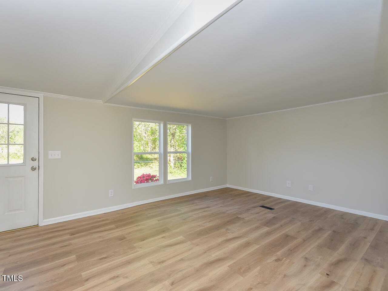 2315 McGhees Mill Road Roxboro, NC 27574 - Photo 15 of 32 a view of an empty room with wooden floor and a window