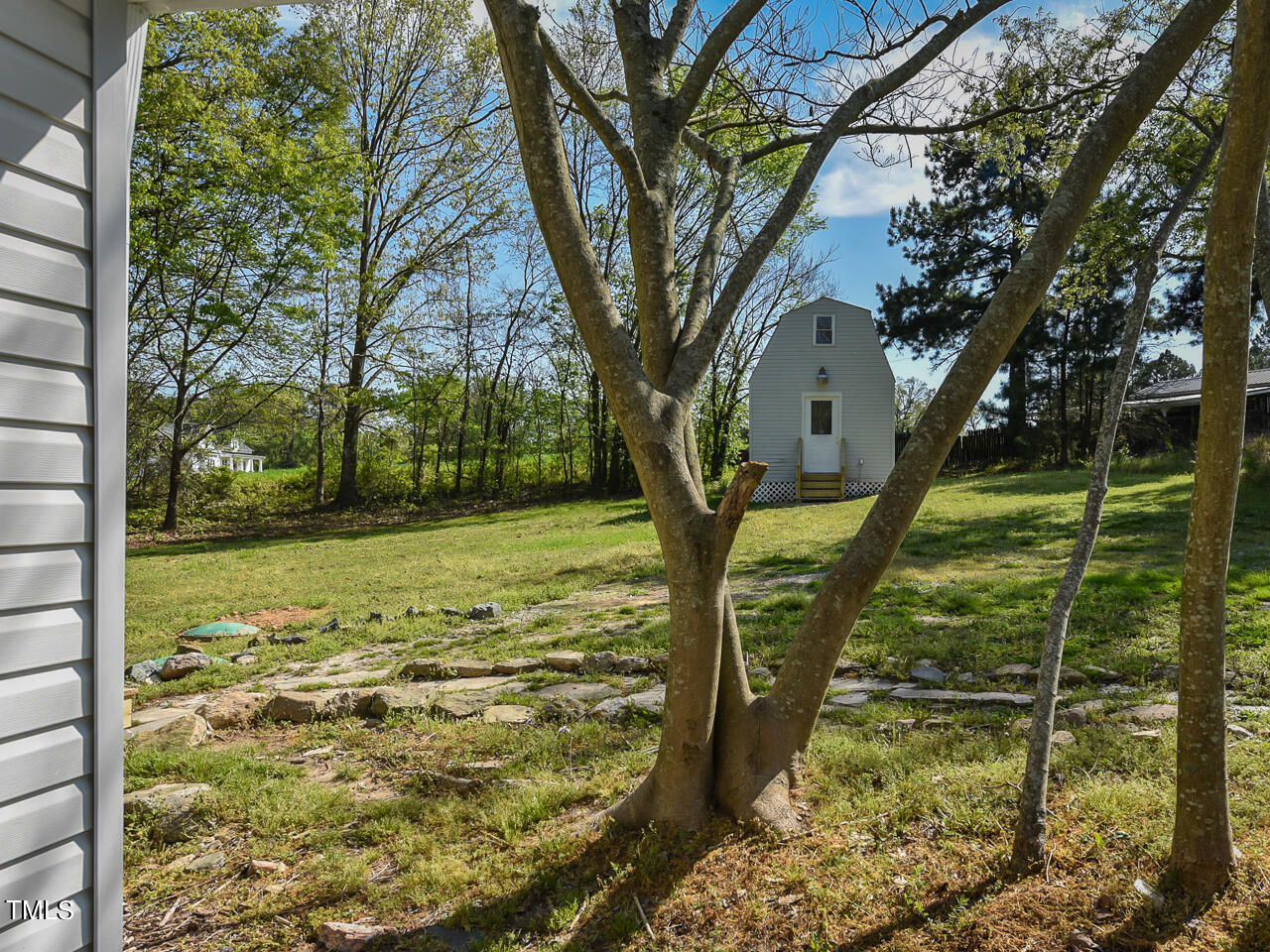2315 McGhees Mill Road Roxboro, NC 27574 - Photo 10 of 32 a view of a yard with an tree