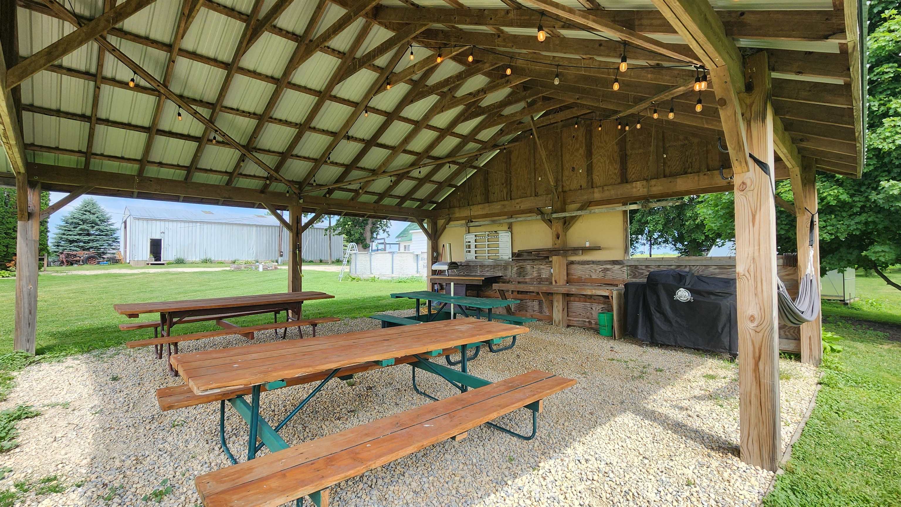 8999 Centerville Road Capron, IL 61012 - Photo 56 of 69 a backyard of a house with barbeque oven table and chairs