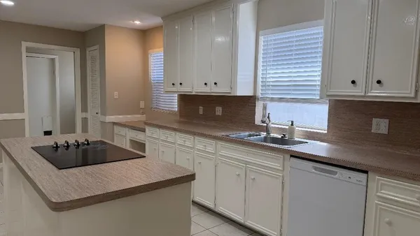 a kitchen with cabinets and sink