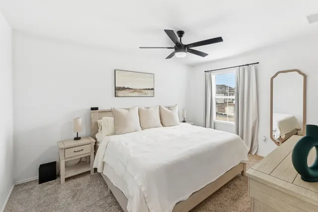 a view of a workspace with furniture and a ceiling fan