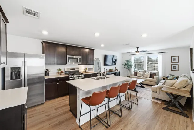 a large kitchen with a table and chairs