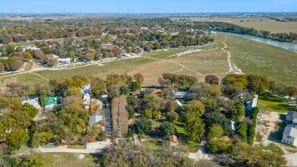 an aerial view of multiple houses with yard