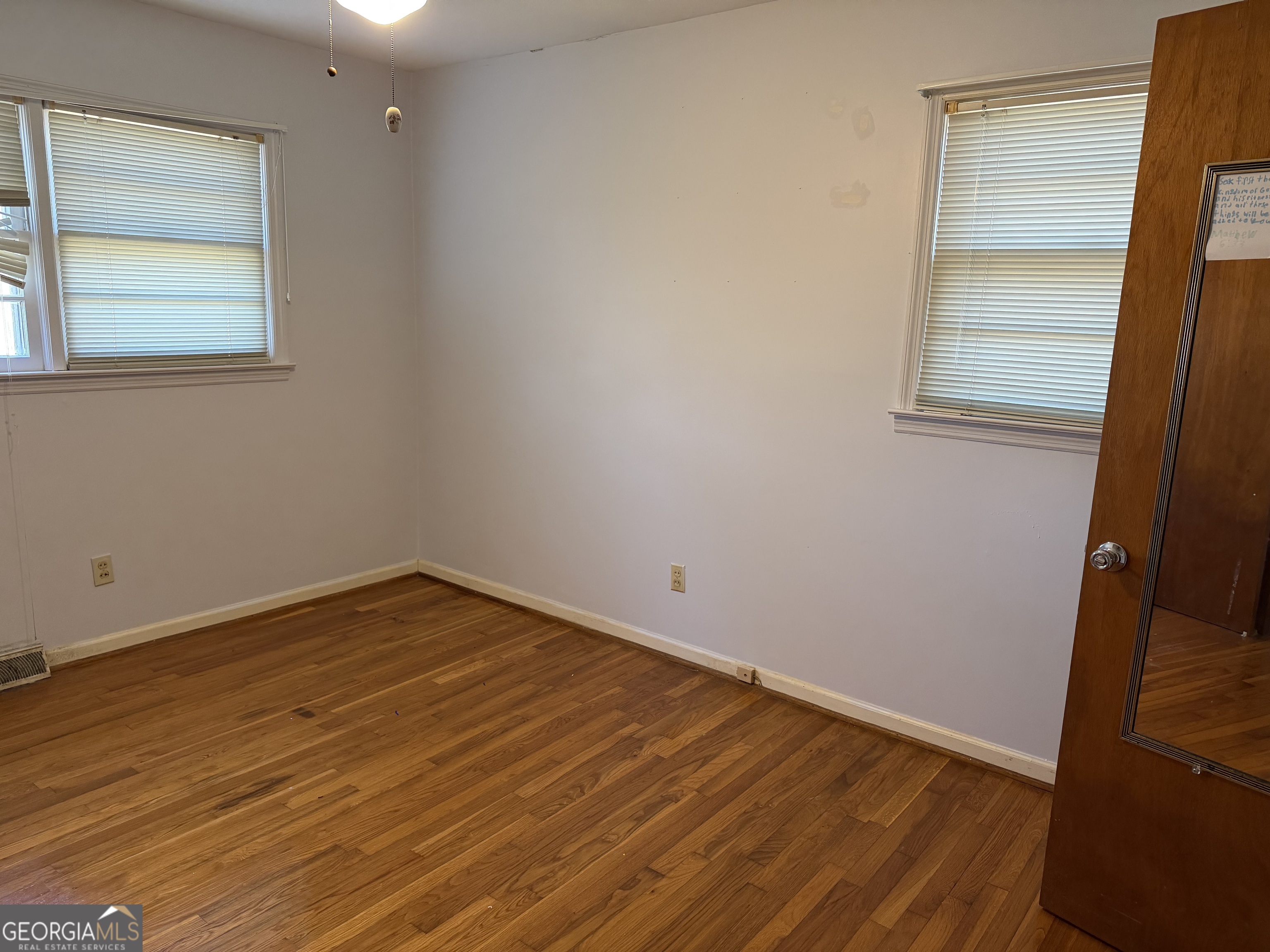 1112 Old Dalton Road Northeast Rome, GA 30165 - Photo 16 of 27 an empty room with wooden floor and windows