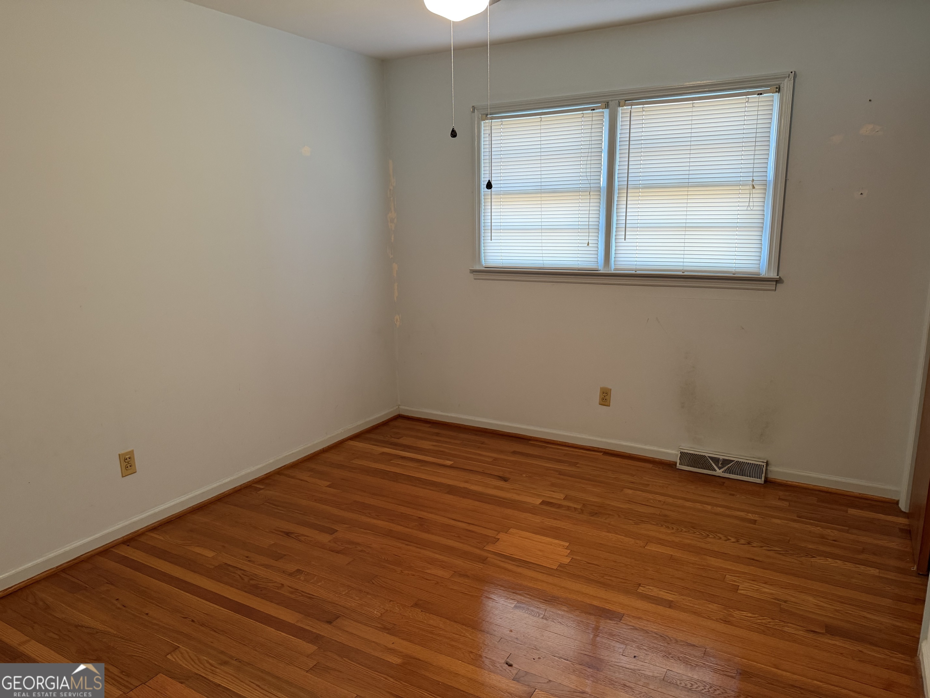 1112 Old Dalton Road Northeast Rome, GA 30165 - Photo 18 of 27 an empty room with wooden floor and windows