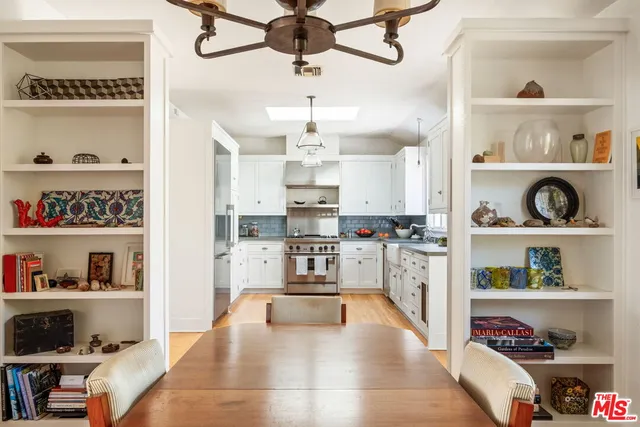 a kitchen with stainless steel appliances granite countertop a refrigerator and stove top oven