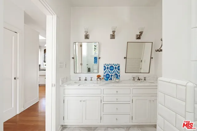 a bathroom with a double vanity sink and mirror