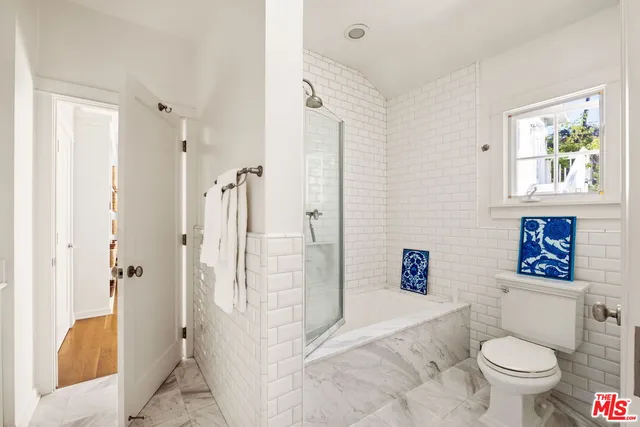 a bathroom with a granite countertop toilet sink and shower