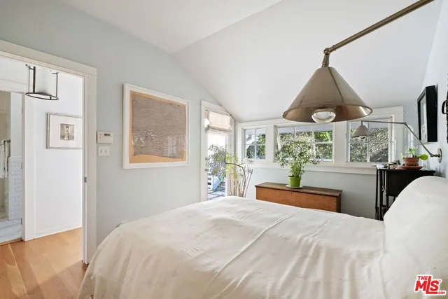 a bedroom with large bed and a large window