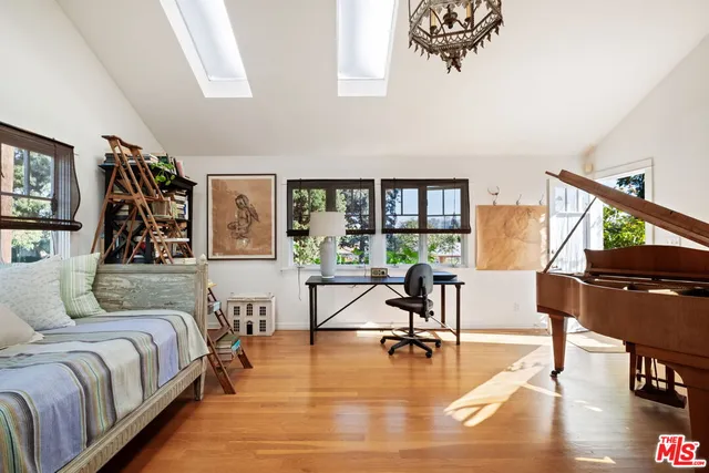 a living room with furniture and a table with wooden floor