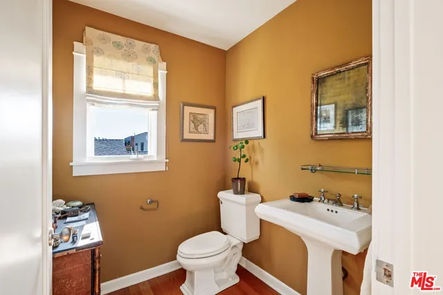 a bathroom with a sink toilet and mirror