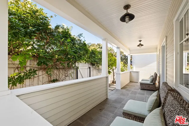 a view of outdoor living space with furniture and garden view