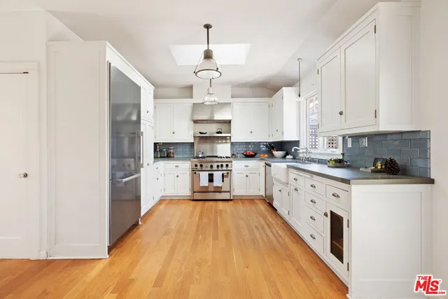 a kitchen with cabinets a sink and appliances