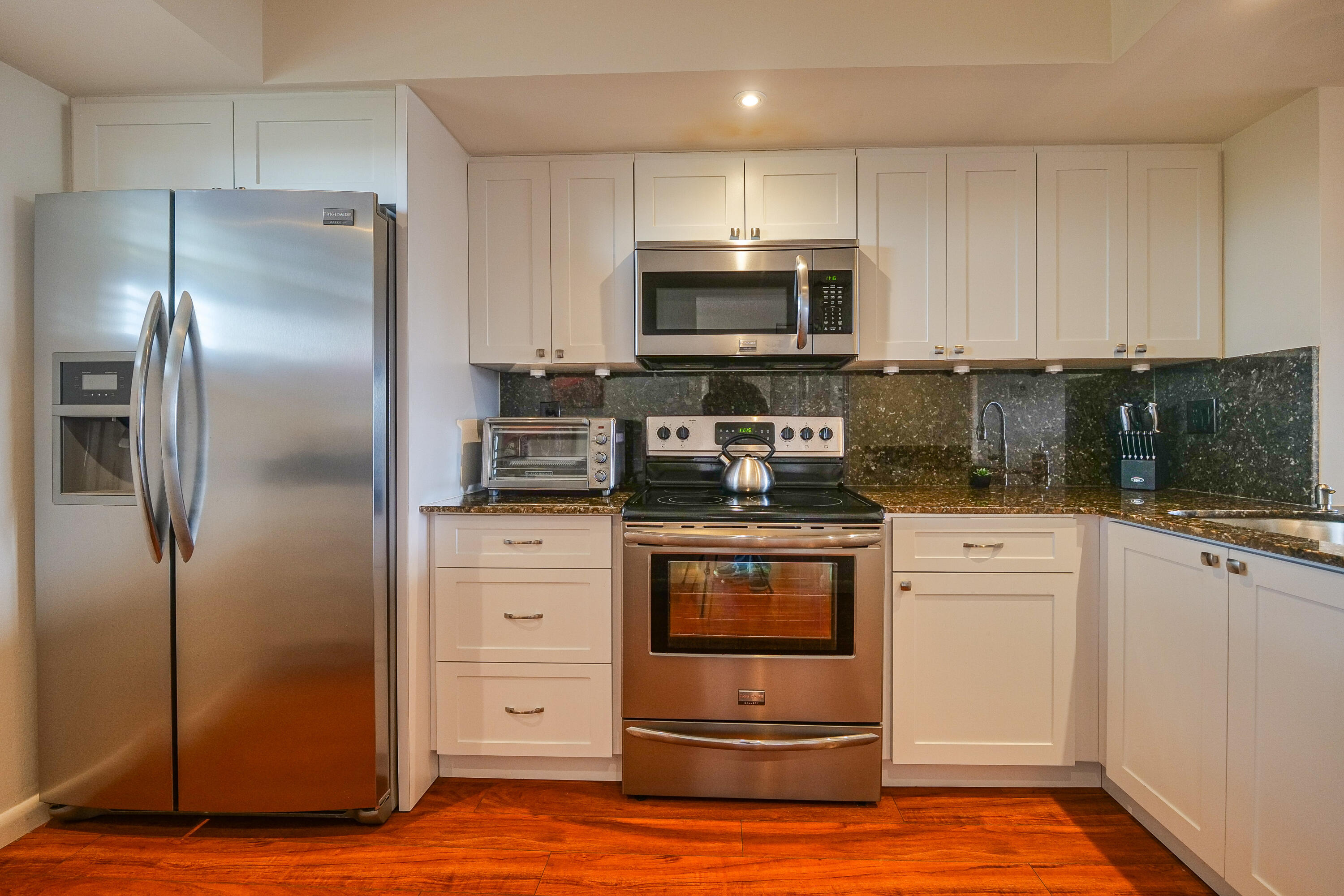 3930 Inverrary Boulevard, Unit 703D Lauderhill, FL 33319 - Photo 12 of 62 a kitchen with a refrigerator sink and cabinets