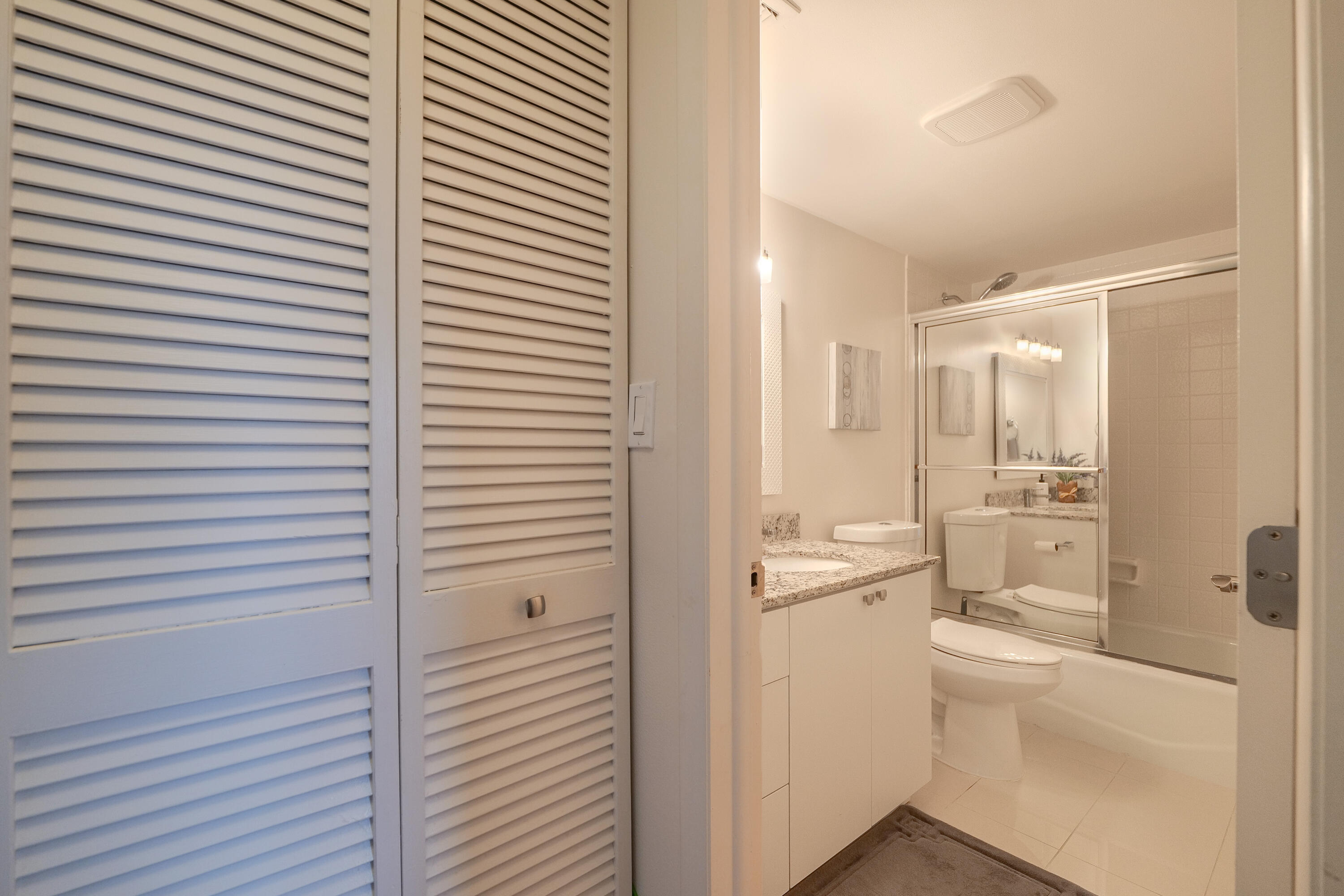3930 Inverrary Boulevard, Unit 703D Lauderhill, FL 33319 - Photo 20 of 62 a bathroom with a sink a toilet and shower