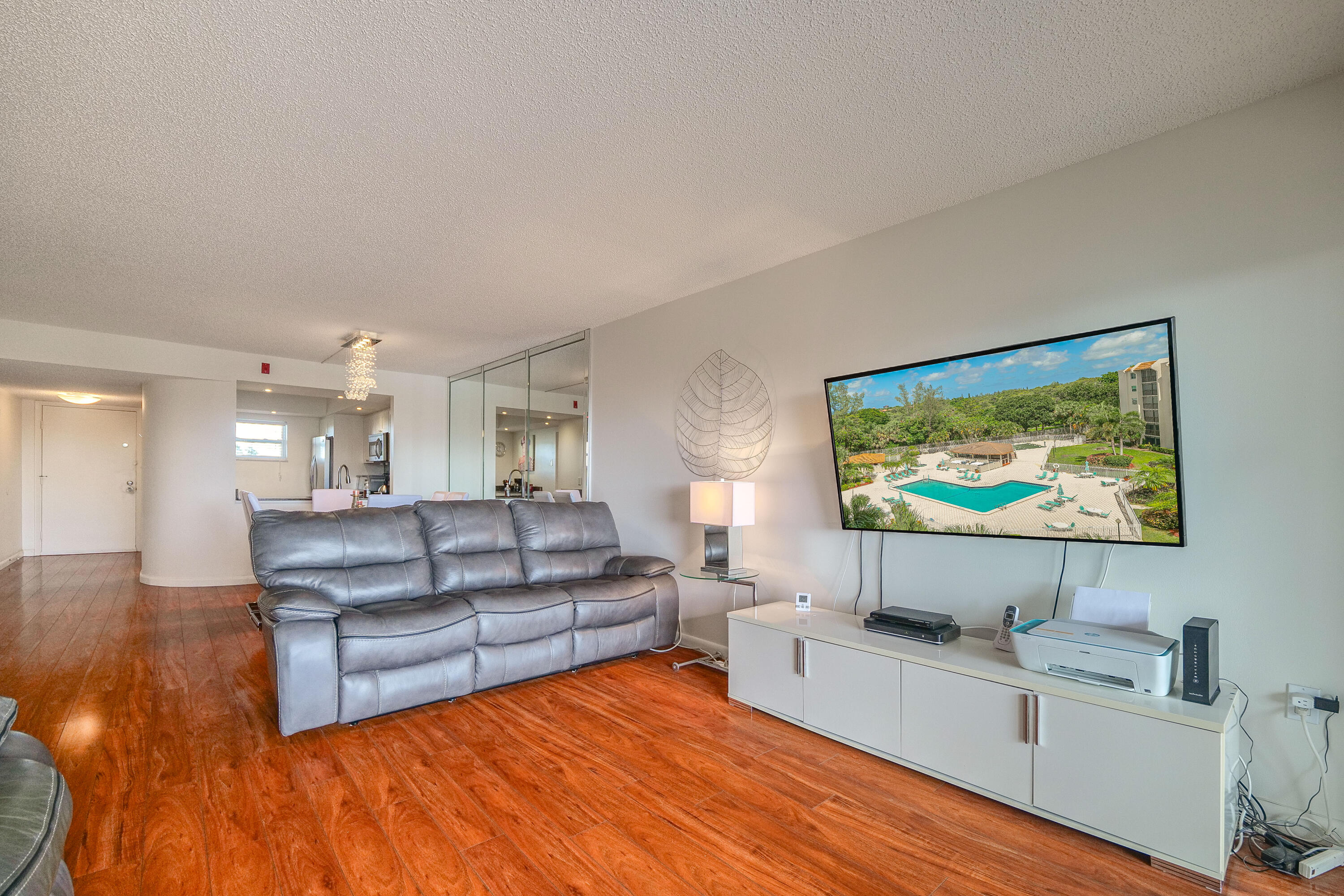 3930 Inverrary Boulevard, Unit 703D Lauderhill, FL 33319 - Photo 2 of 62 a living room with furniture and a flat screen tv
