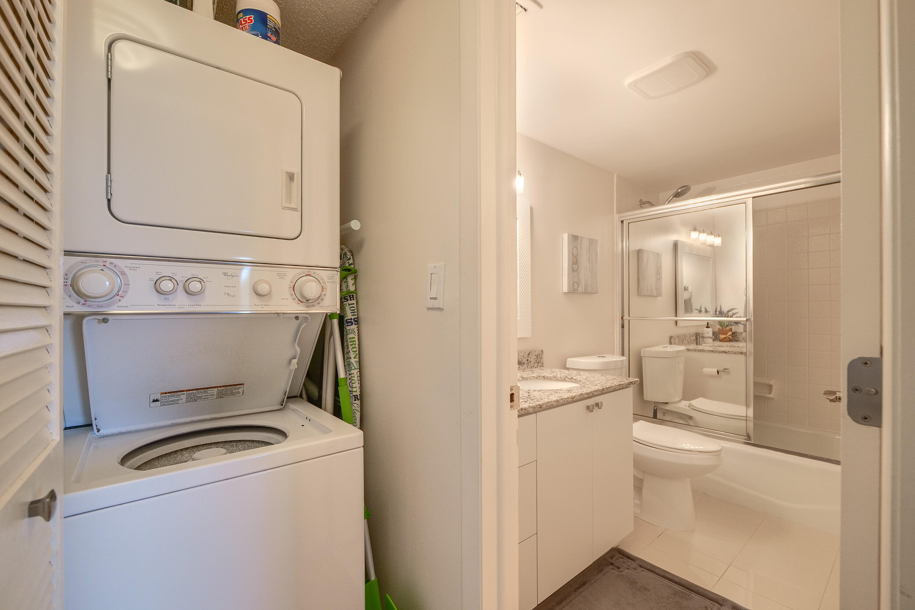 3930 Inverrary Boulevard, Unit 703D Lauderhill, FL 33319 - Photo 22 of 62 a bathroom with a toilet sink and a mirror