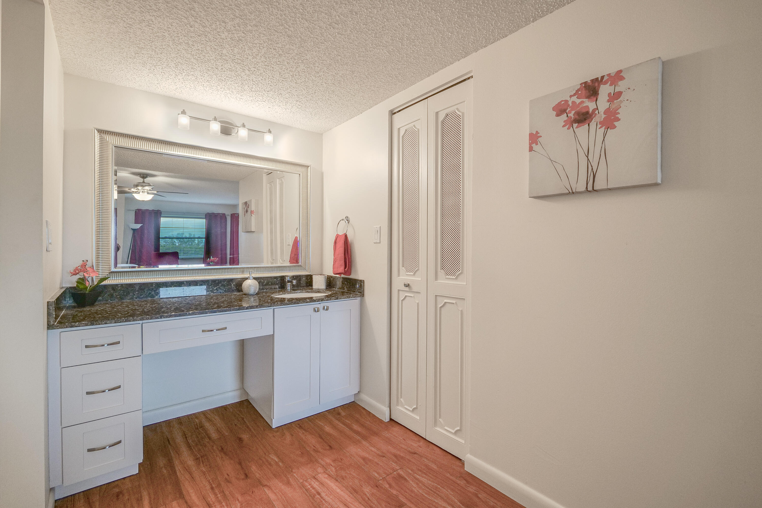 3930 Inverrary Boulevard, Unit 703D Lauderhill, FL 33319 - Photo 30 of 62 a bathroom with a granite countertop sink and a mirror