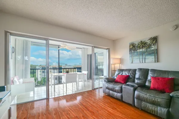 a living room with furniture and a floor to ceiling window