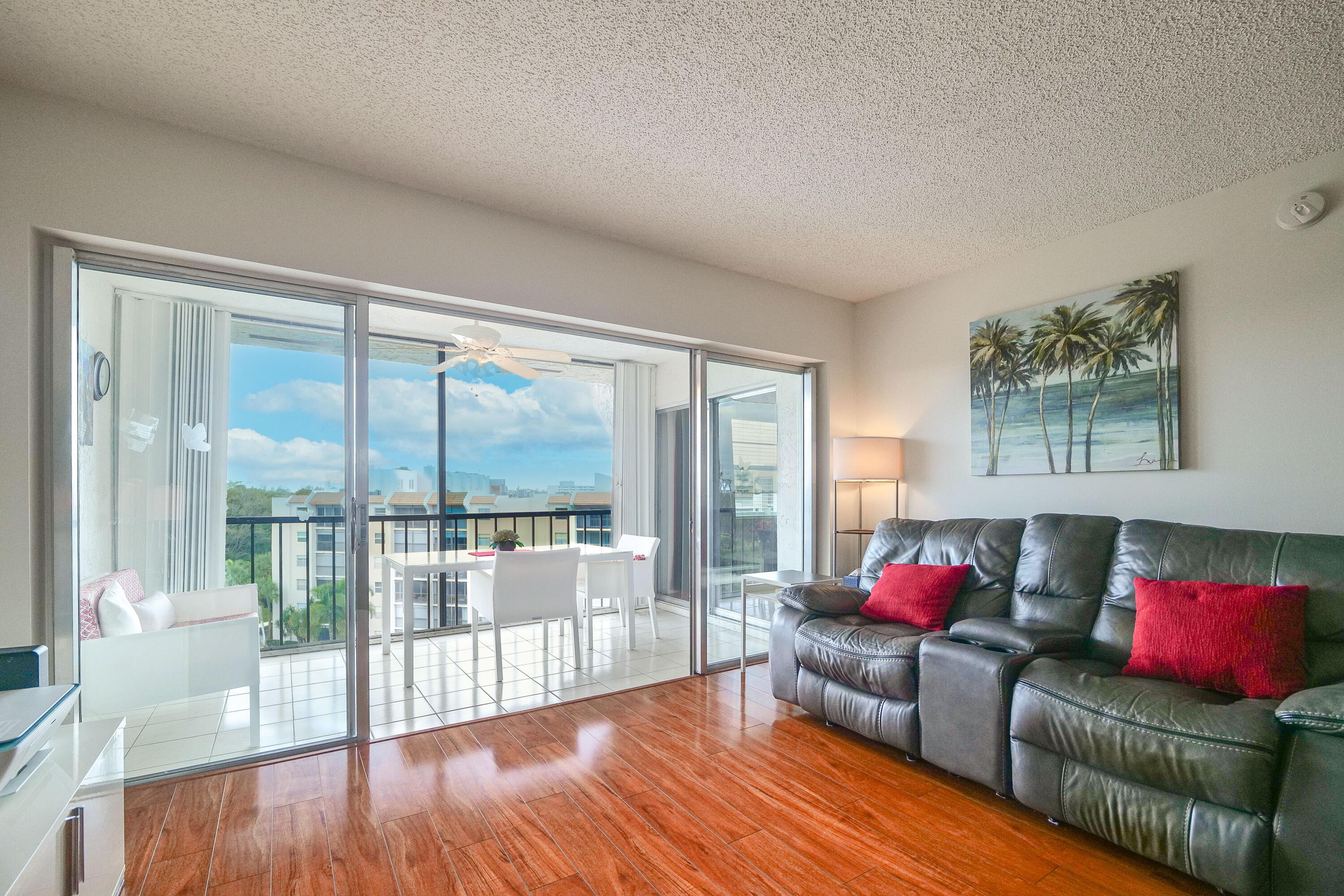 3930 Inverrary Boulevard, Unit 703D Lauderhill, FL 33319 - Photo 3 of 62 a living room with furniture and a floor to ceiling window