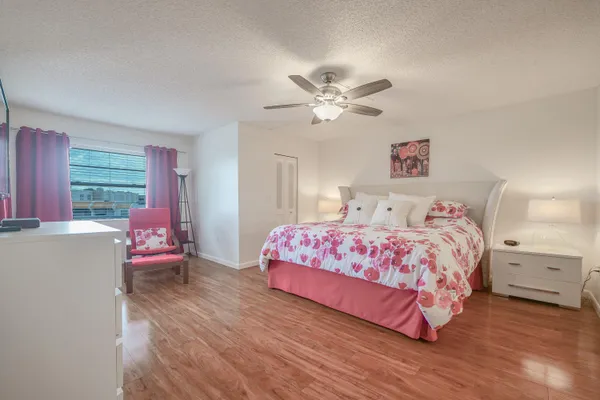 a bedroom with a large bed and a chandelier