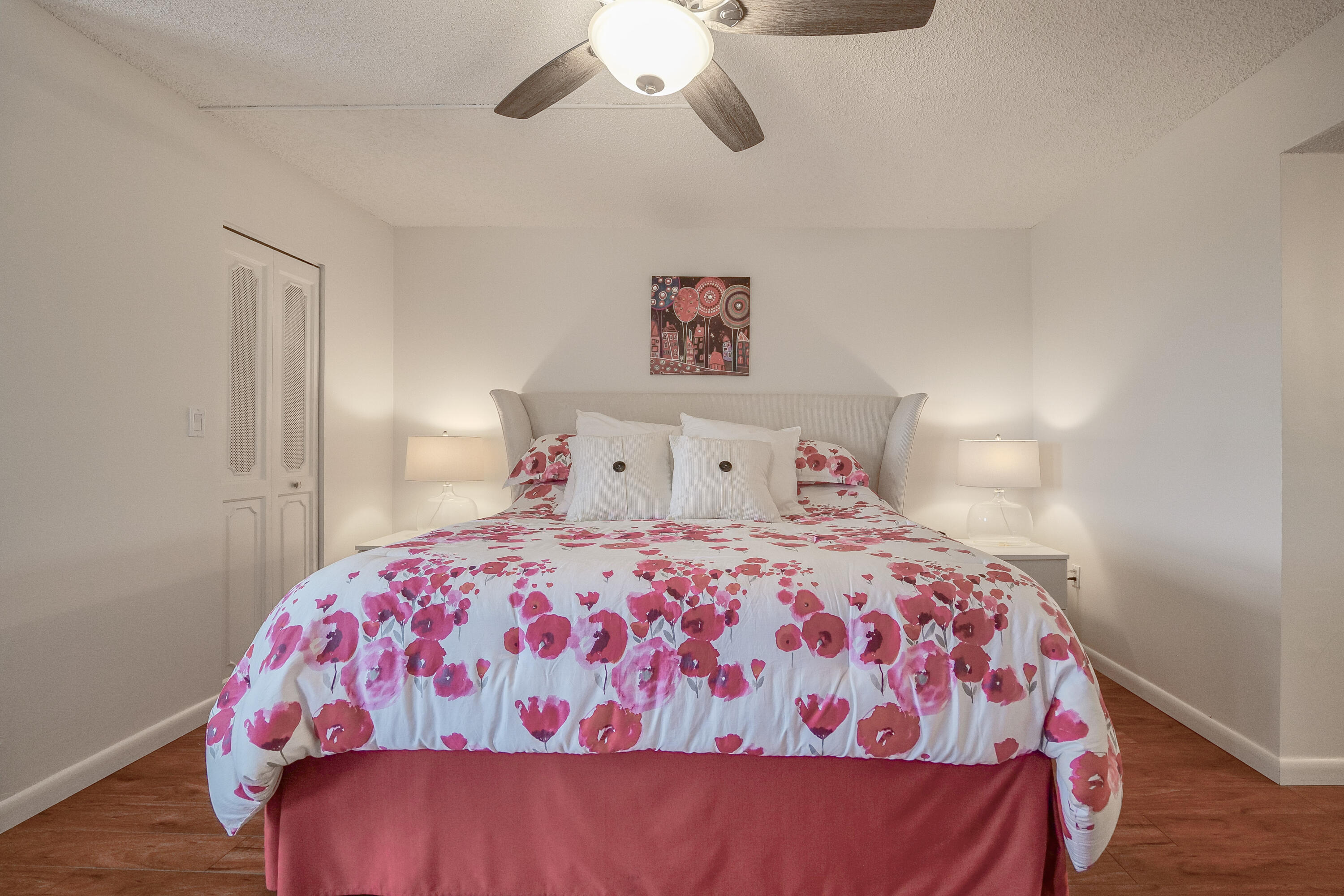 3930 Inverrary Boulevard, Unit 703D Lauderhill, FL 33319 - Photo 35 of 62 a bedroom with a bed and a chandelier