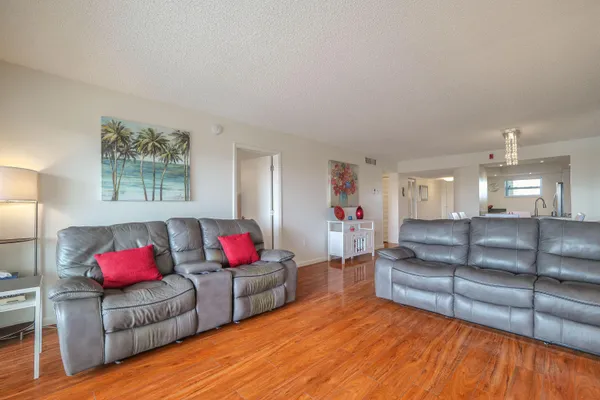 a living room with furniture and kitchen view